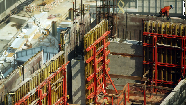 Construction workers continue to work on one of the four office towers being built on the site on Friday.